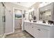 Bright bathroom with a double sink vanity, modern fixtures, and a tiled walk-in shower at 20846 E Longwood Dr, Queen Creek, AZ 85142