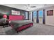 A primary bedroom features a black accent wall, large windows, and a ceiling fan at 20846 E Longwood Dr, Queen Creek, AZ 85142