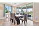 Dining room with wood table, upholstered chairs, slider doors that lead to outdoor dining space and backyard at 20846 E Longwood Dr, Queen Creek, AZ 85142