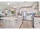 This bright kitchen boasts a large island, stainless appliances, sleek white cabinets, and pendant lighting at 20846 E Longwood Dr, Queen Creek, AZ 85142