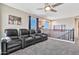 A well-lit loft features tiered seating, a ceiling fan, and a view from the home's second story at 20846 E Longwood Dr, Queen Creek, AZ 85142