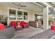 Inviting covered patio features red cushioned seating, a hot tub, and a ceiling fan for outdoor relaxation at 20846 E Longwood Dr, Queen Creek, AZ 85142