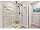 Modern walk-in shower features bright tile and a wooden bench at 20846 E Longwood Dr, Queen Creek, AZ 85142