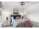 Cozy bedroom with soft lighting, comfortable bed with stylish pillows, and a modern art piece at 21320 N 56Th St # 2005, Phoenix, AZ 85054