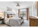 Bright bedroom with a large window, chandelier, comfortable bed with stylish pillows and neutral decor at 21320 N 56Th St # 2005, Phoenix, AZ 85054