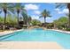 Inviting community pool surrounded by palm trees and comfortable lounge seating at 21320 N 56Th St # 2005, Phoenix, AZ 85054