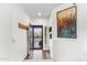 Inviting entryway with hardwood floors, decorative art, and a secure screen door at 21320 N 56Th St # 2005, Phoenix, AZ 85054