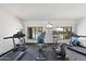 Modern fitness center with treadmills, stationary bikes, and community pool view at 21320 N 56Th St # 2005, Phoenix, AZ 85054