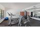 A fitness center equipped with machines and weights, with a mirrored wall and bright light at 21320 N 56Th St # 2005, Phoenix, AZ 85054