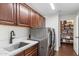 Well-equipped laundry room with stainless steel washer and dryer and ample cabinetry at 21320 N 56Th St # 2005, Phoenix, AZ 85054