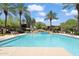 Beautiful community pool with palm trees, lounge chairs, and well-maintained landscaping at 21320 N 56Th St # 2005, Phoenix, AZ 85054