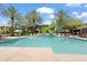 A resort-style community pool is surrounded by mature landscaping and various seating areas at 21320 N 56Th St # 2005, Phoenix, AZ 85054