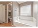 Bathroom features a built-in tub with white tile surround and neutral paint at 2640 S Terripin Cir, Mesa, AZ 85209