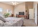 Bedroom featuring neutral walls, a ceiling fan, desk, and access to ensuite bathroom at 2640 S Terripin Cir, Mesa, AZ 85209