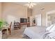 Bedroom features a ceiling fan, a television, and access to the ensuite bathroom at 2640 S Terripin Cir, Mesa, AZ 85209