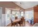 Dining area with lots of light, a chandelier, and backyard views of the pool at 2640 S Terripin Cir, Mesa, AZ 85209