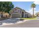 Charming two-story home with a well-manicured lawn, a palm tree, and a driveway at 2640 S Terripin Cir, Mesa, AZ 85209