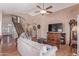 Living room featuring wood floors, a staircase, and a large TV at 2640 S Terripin Cir, Mesa, AZ 85209