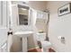 Powder room featuring a pedestal sink, white fixtures, and wood-look floors at 2640 S Terripin Cir, Mesa, AZ 85209