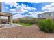 Well-maintained backyard featuring a patio, vibrant green grass, and lush landscaping, perfect for outdoor entertaining at 265 W Rainbow Bridge Ln, San Tan Valley, AZ 85140