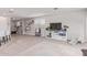 Bright living room featuring neutral tones, a large TV, and playful decor at 265 W Rainbow Bridge Ln, San Tan Valley, AZ 85140