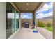 Covered patio with outdoor grill, brick pavers and a basketball hoop against a privacy wall at 265 W Rainbow Bridge Ln, San Tan Valley, AZ 85140