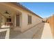 Covered back patio with ceiling fans, outdoor dining, and a clean concrete walkway at 27255 N 81St Ln, Peoria, AZ 85383