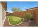 Beautiful backyard featuring a putting green, covered patio, and desert landscaping at 27255 N 81St Ln, Peoria, AZ 85383