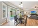 Bright dining area with wood floors, leading to a patio through large glass doors, perfect for entertaining at 27255 N 81St Ln, Peoria, AZ 85383