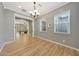 Bright dining room featuring wood floors, a chandelier, and an open view to the living room at 27255 N 81St Ln, Peoria, AZ 85383