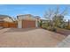 Inviting home with a brick driveway and neutral tones, featuring a two-car garage and desert landscaping at 27255 N 81St Ln, Peoria, AZ 85383