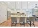 Well-lit kitchen with stainless steel appliances, sleek cabinetry, and an island with barstool seating at 27255 N 81St Ln, Peoria, AZ 85383