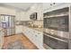 Modern kitchen with white cabinets, granite countertops, and stainless steel appliances, creating a bright and functional space at 27255 N 81St Ln, Peoria, AZ 85383