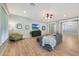 Comfortable living room with contemporary decor, a ceiling fan, and wood-look flooring at 27255 N 81St Ln, Peoria, AZ 85383