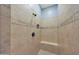 Tiled walk-in shower with built-in seat and decorative accent tiles at 27255 N 81St Ln, Peoria, AZ 85383