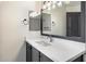 Bright bathroom featuring a framed mirror, a vanity with white countertop, and wood cabinet at 280 S Evergreen Rd # 1336, Tempe, AZ 85288