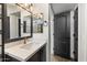 A modern bathroom featuring a square mirror, vanity with cabinet and countertop, and a door into the bathroom at 280 S Evergreen Rd # 1336, Tempe, AZ 85288