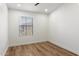 A clean bedroom with wood floors, bright natural lighting, and pristine white walls at 280 S Evergreen Rd # 1336, Tempe, AZ 85288