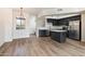 Open-concept kitchen and dining space, featuring a kitchen island, stainless steel appliances, and wood floors at 280 S Evergreen Rd # 1336, Tempe, AZ 85288