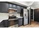 A modern kitchen featuring stainless steel appliances, white countertops, and sleek dark gray cabinets at 280 S Evergreen Rd # 1336, Tempe, AZ 85288