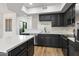 Stylish kitchen featuring an island with a white countertop, black cabinets, and stainless steel appliances at 280 S Evergreen Rd # 1336, Tempe, AZ 85288