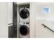 A contemporary laundry room featuring a stacked washer and dryer and a glimpse of natural light at 280 S Evergreen Rd # 1336, Tempe, AZ 85288