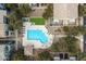 An aerial view showcases a community pool surrounded by lounge chairs and lush landscaping at 280 S Evergreen Rd # 1336, Tempe, AZ 85288