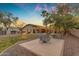 Sprawling backyard featuring a pool, fire pit, and lush landscaping at 2876 E Cherrywood Pl, Chandler, AZ 85249