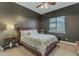 Cozy bedroom showcasing dark walls and a wood-framed bed with a patterned duvet at 2876 E Cherrywood Pl, Chandler, AZ 85249