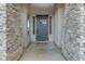 Front entrance with stone pillars, a gray door, and window accents at 2876 E Cherrywood Pl, Chandler, AZ 85249