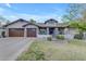 Charming home with a three-car garage, stone accents, and a manicured lawn at 2876 E Cherrywood Pl, Chandler, AZ 85249