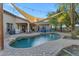 Backyard swimming pool surrounded by lush landscaping and shaded seating areas at 2876 E Cherrywood Pl, Chandler, AZ 85249