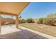 The backyard is shaded by a covered patio and surrounded by a block wall for privacy at 29900 N Maravilla Dr, San Tan Valley, AZ 85143