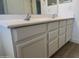 Bathroom featuring a dual sink vanity, white cabinets, and silver hardware at 29900 N Maravilla Dr, San Tan Valley, AZ 85143